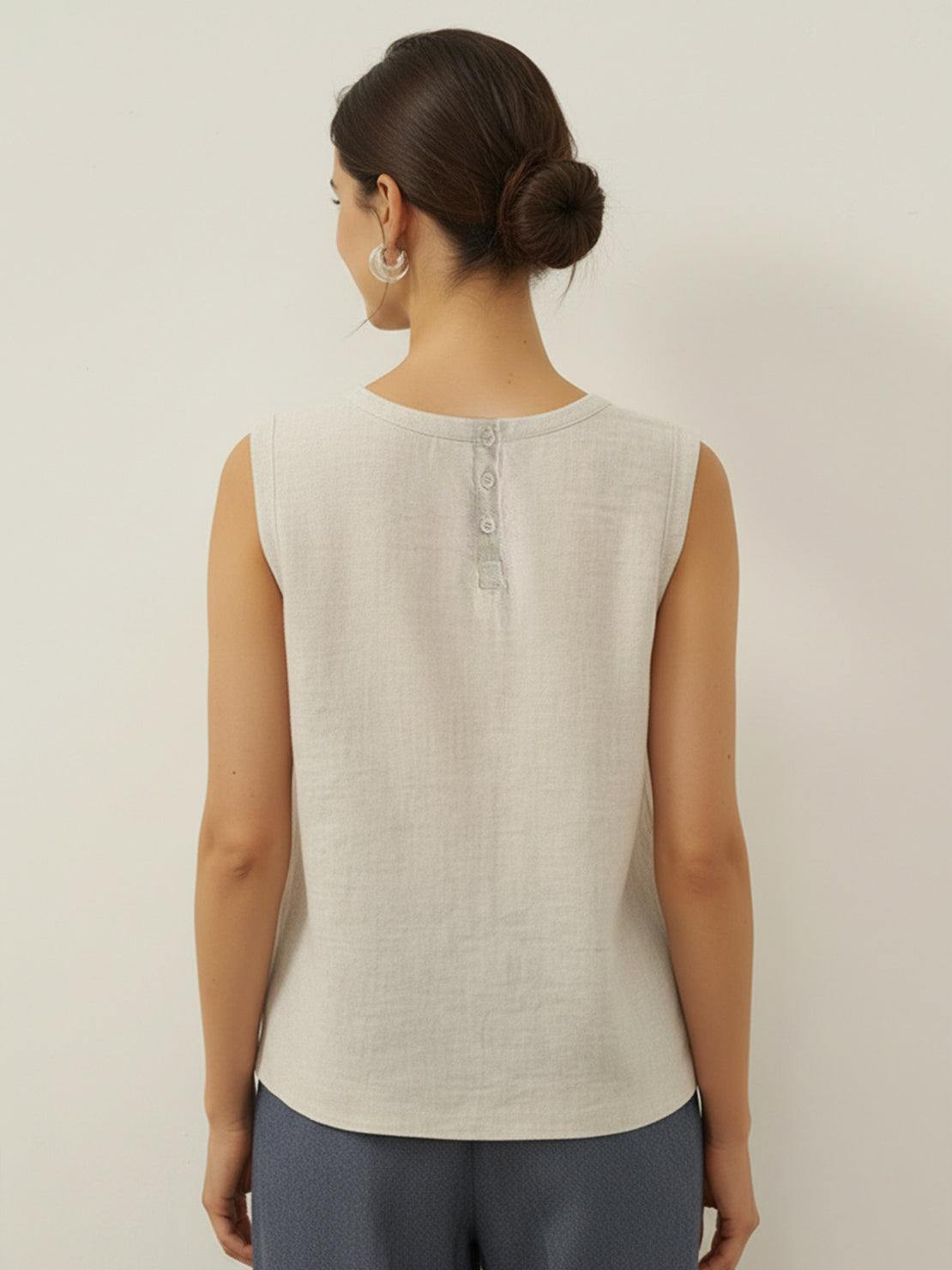 White cotton-linen sleeveless top with round neckline and button back closure