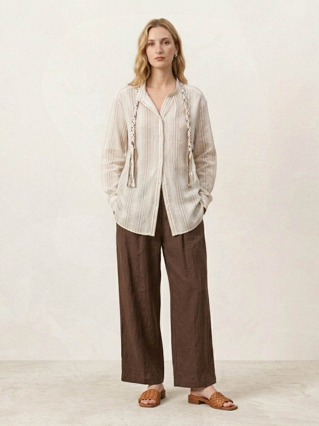 Linen-cotton shirt with vertical stripes, braided tassel trim, drop shoulders, and button cuffs
