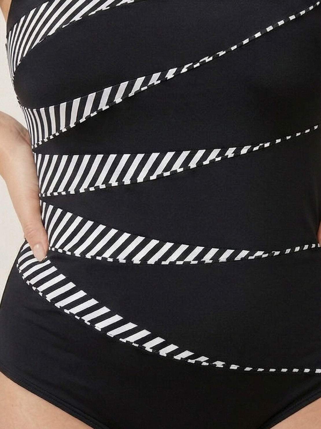 Curve-fit open-back swimsuit with scoop front, adjustable straps, and diagonal back panels in black polyester.