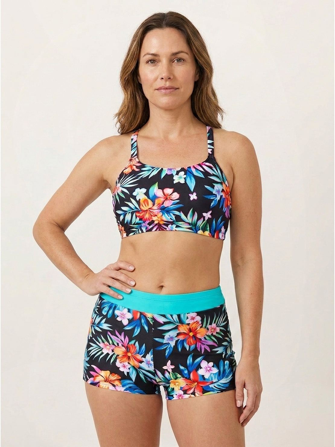 Three-piece open-back swim set with loose tank, printed racerback crop bra, and mid-rise swim shorts