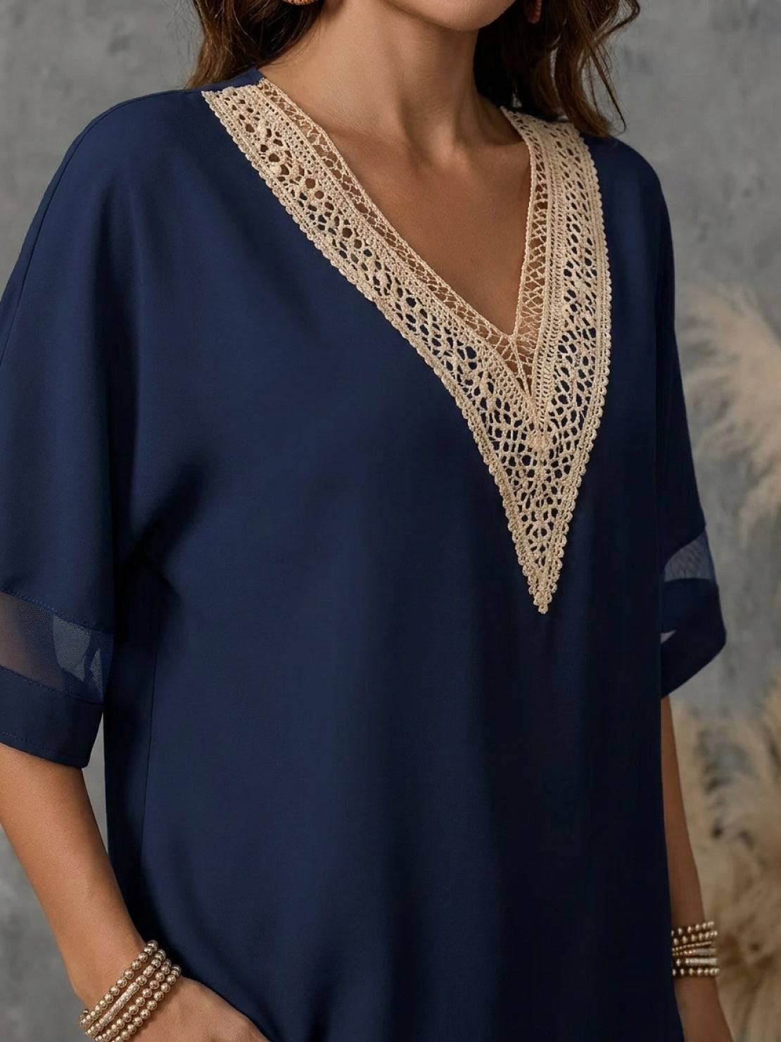 Mature woman wearing a lightweight linen top with V-neck and button detail in light khaki