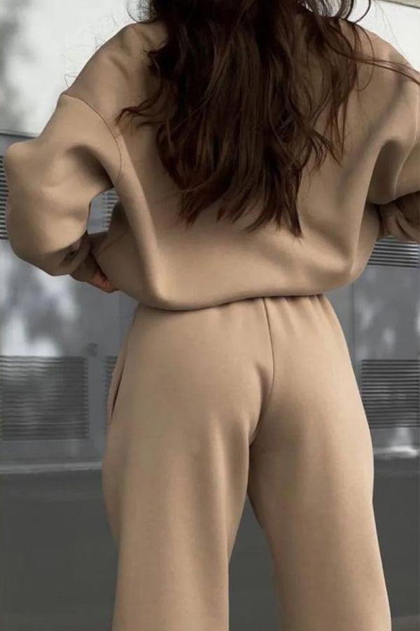 Woman wearing a comfortable cotton-blended two-piece tracksuit with high collar and zipper