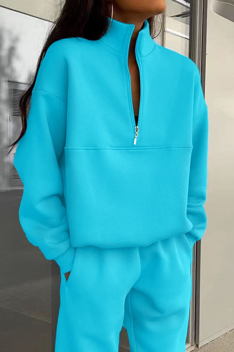 Woman wearing a soft cotton-blended two-piece monochrome tracksuit with high collar and zipper