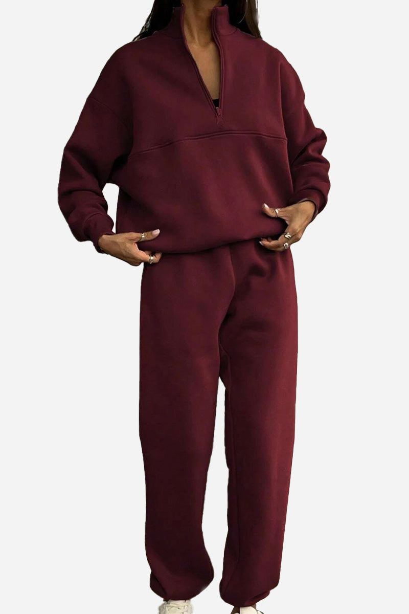 woman wearing cotton-blended two-piece tracksuit with high collar and zipper