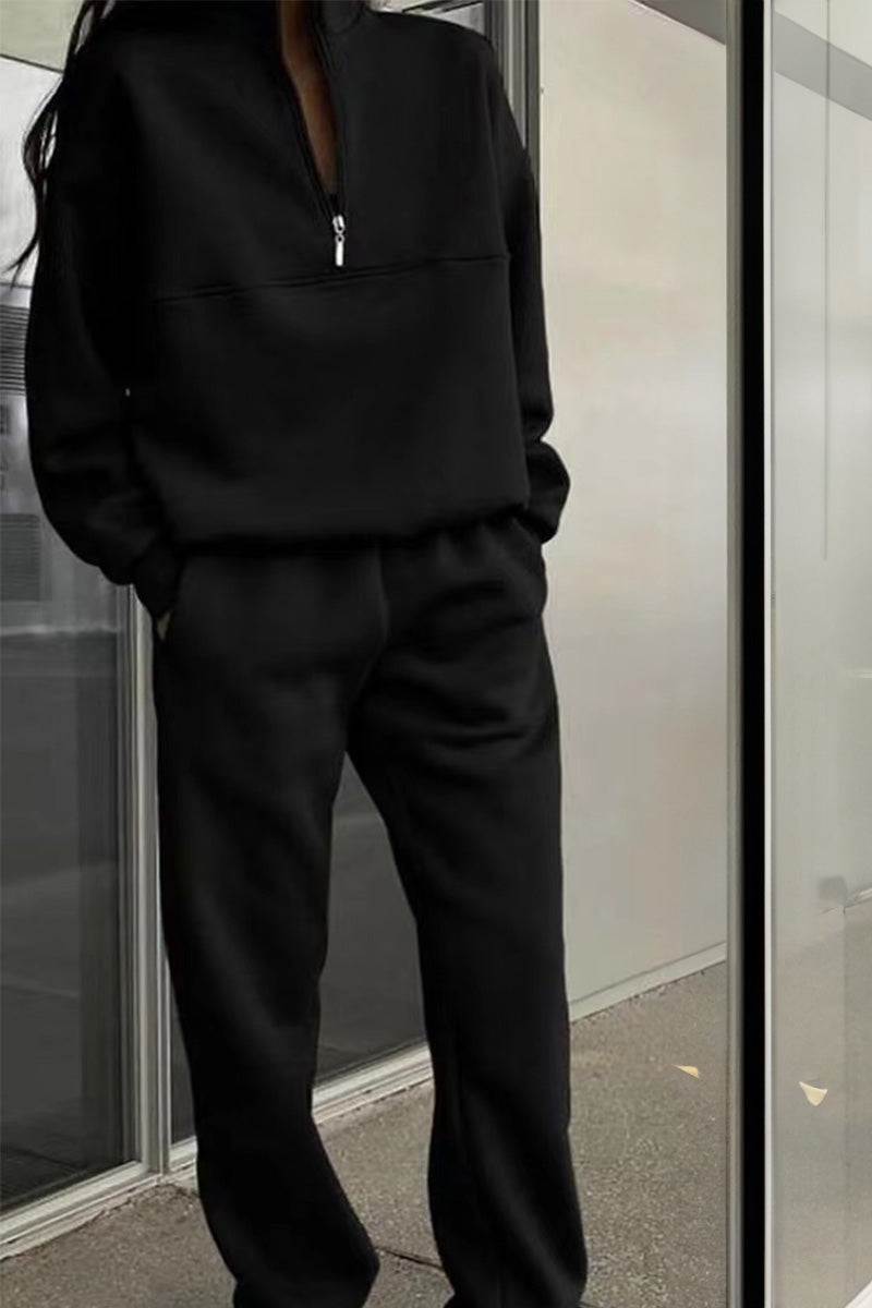 woman wearing cotton-blended two-piece tracksuit with high collar and zipper detailing