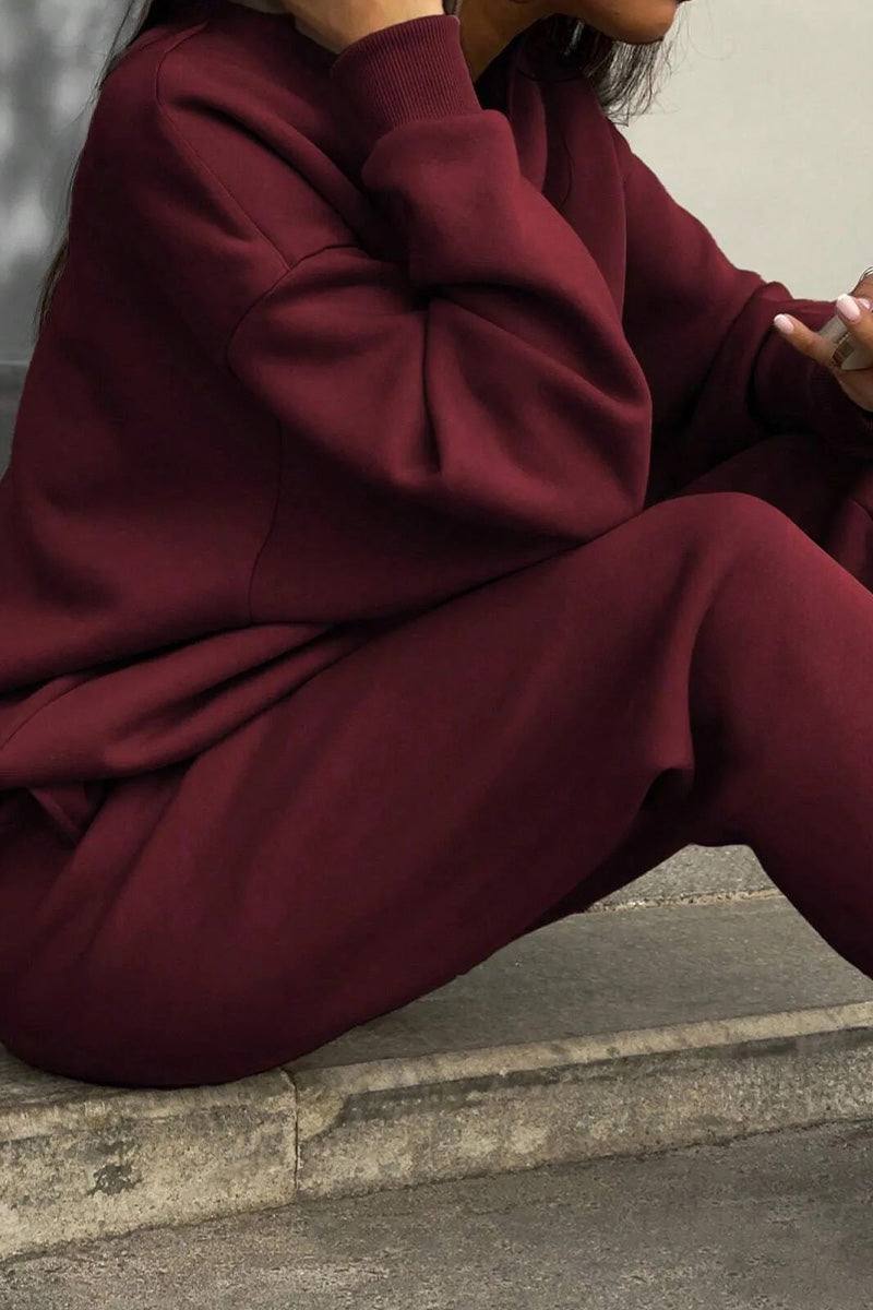 woman wearing cotton-blended two-piece tracksuit with high collar and zipper in monochrome design