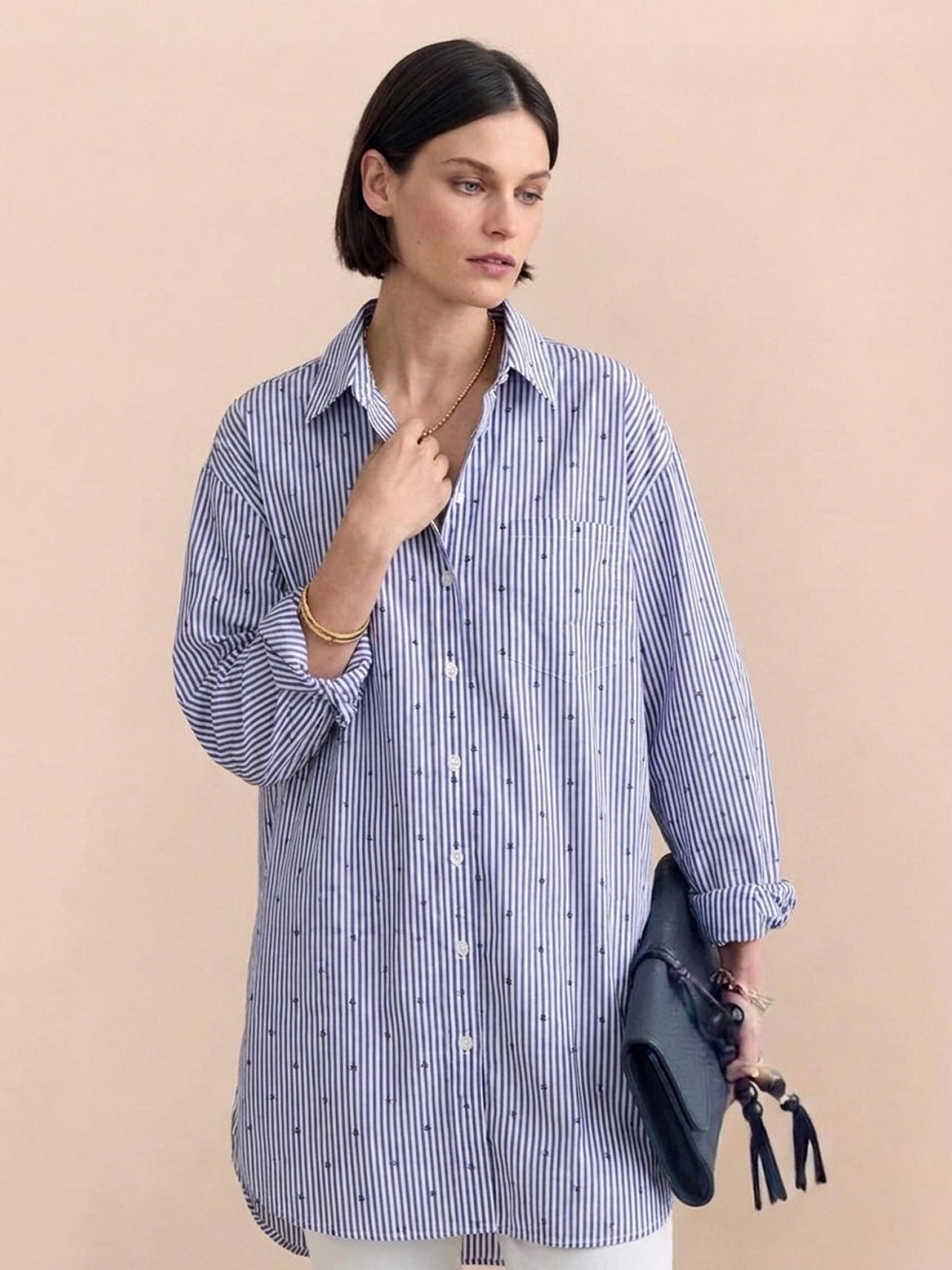 Oversized linen shirt in relaxed fit with back-pleat detail and button-up design