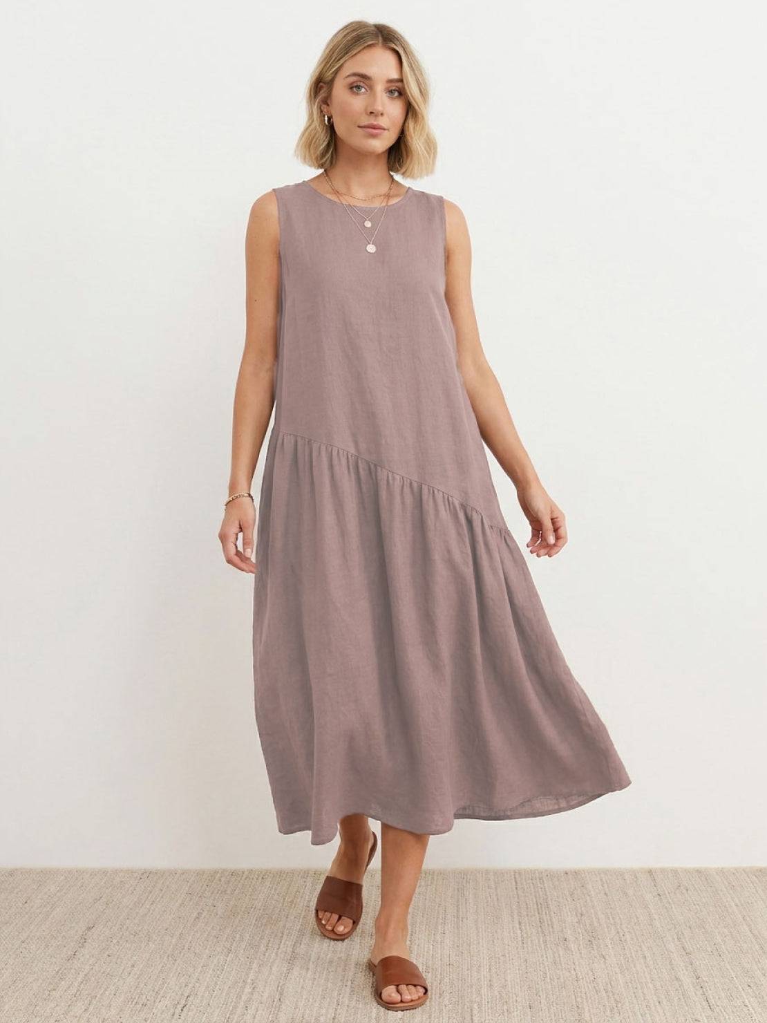 Woman wearing a cotton-linen summer midi dress with tiered skirt and relaxed drop-waist silhouette