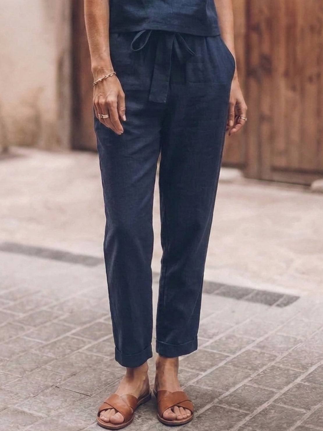 Woman wearing a relaxed cotton linen set with short sleeve top and straight-leg pants in monochrome tones