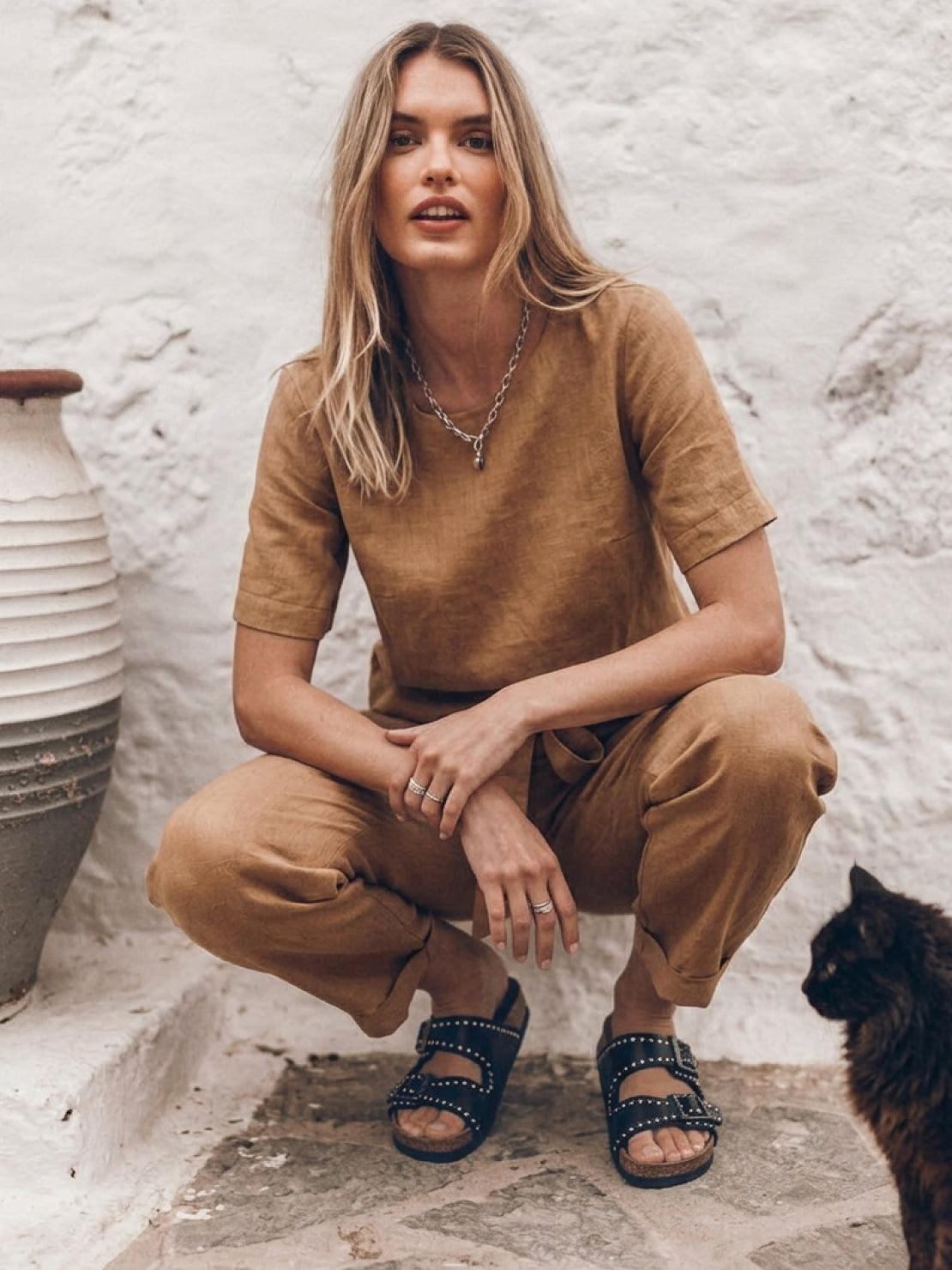 flat lay of relaxed cotton-linen set with short-sleeve top and straight-leg pants in monochrome tones