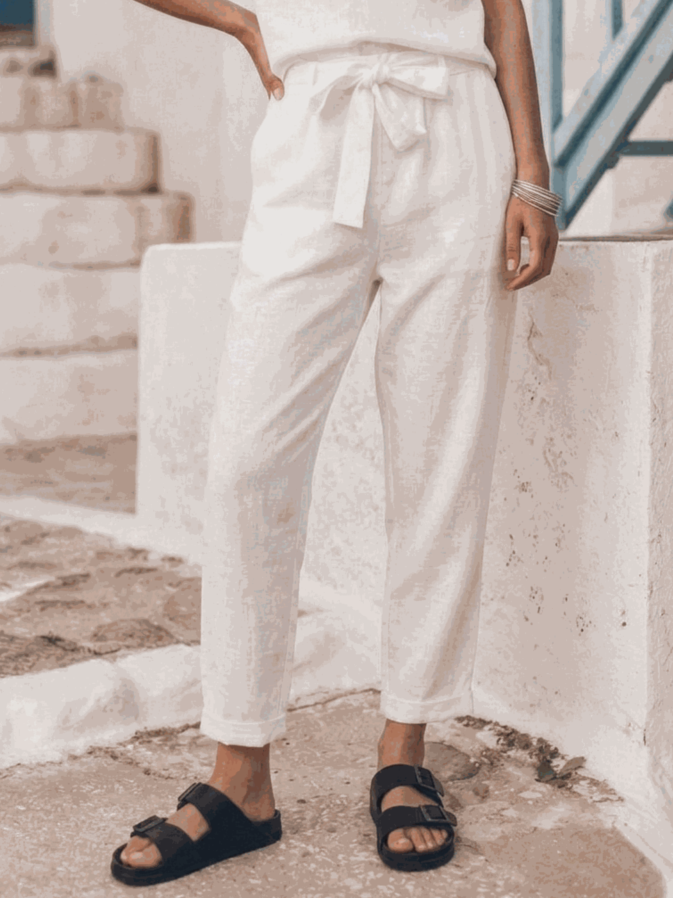 Woman wearing relaxed cotton-linen set with short-sleeve top and straight-leg pants in monochrome tones