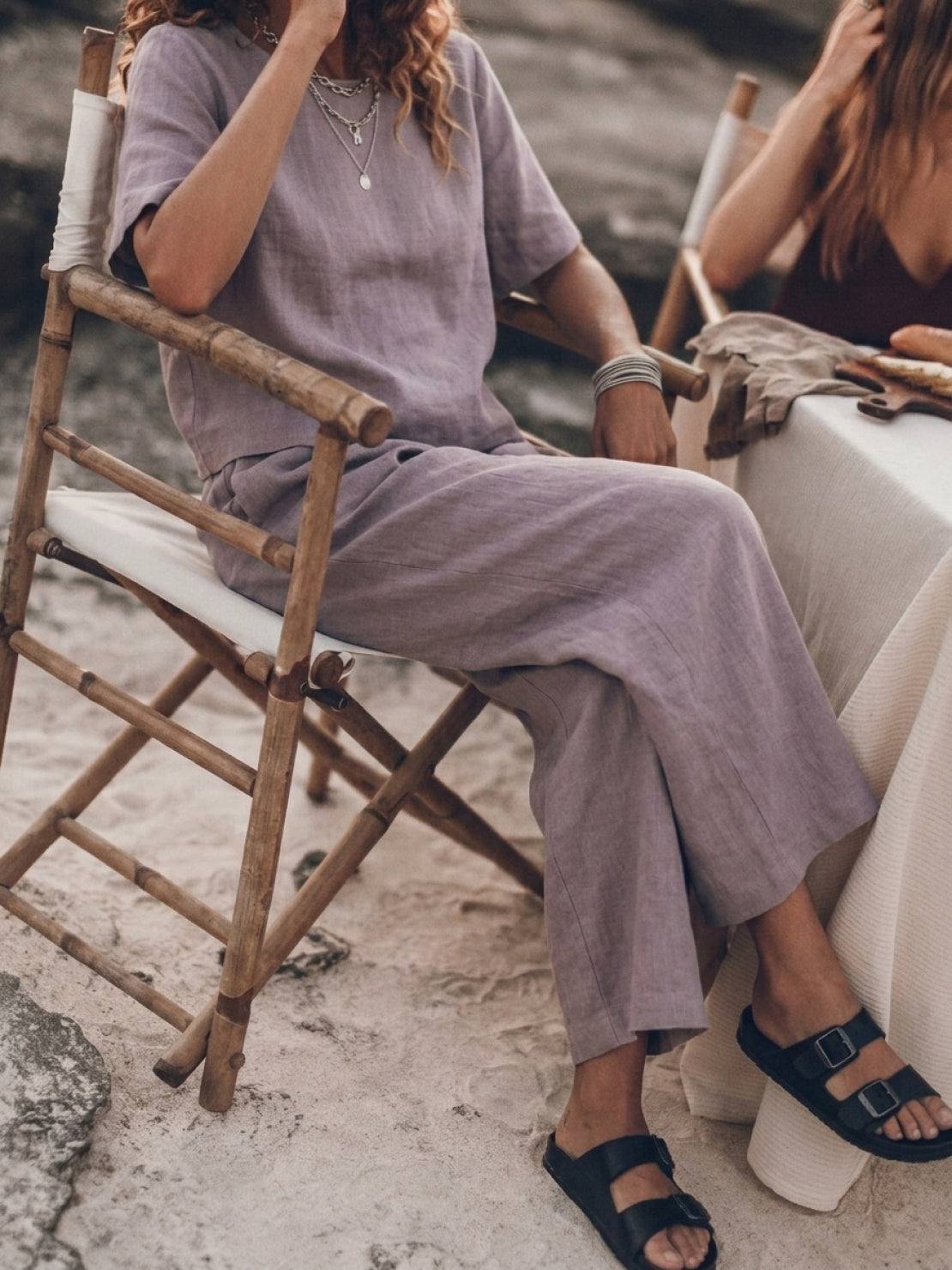 woman wearing loose fit co-ord set with soft-tailored top and wide-leg bottoms in light cotton fabric