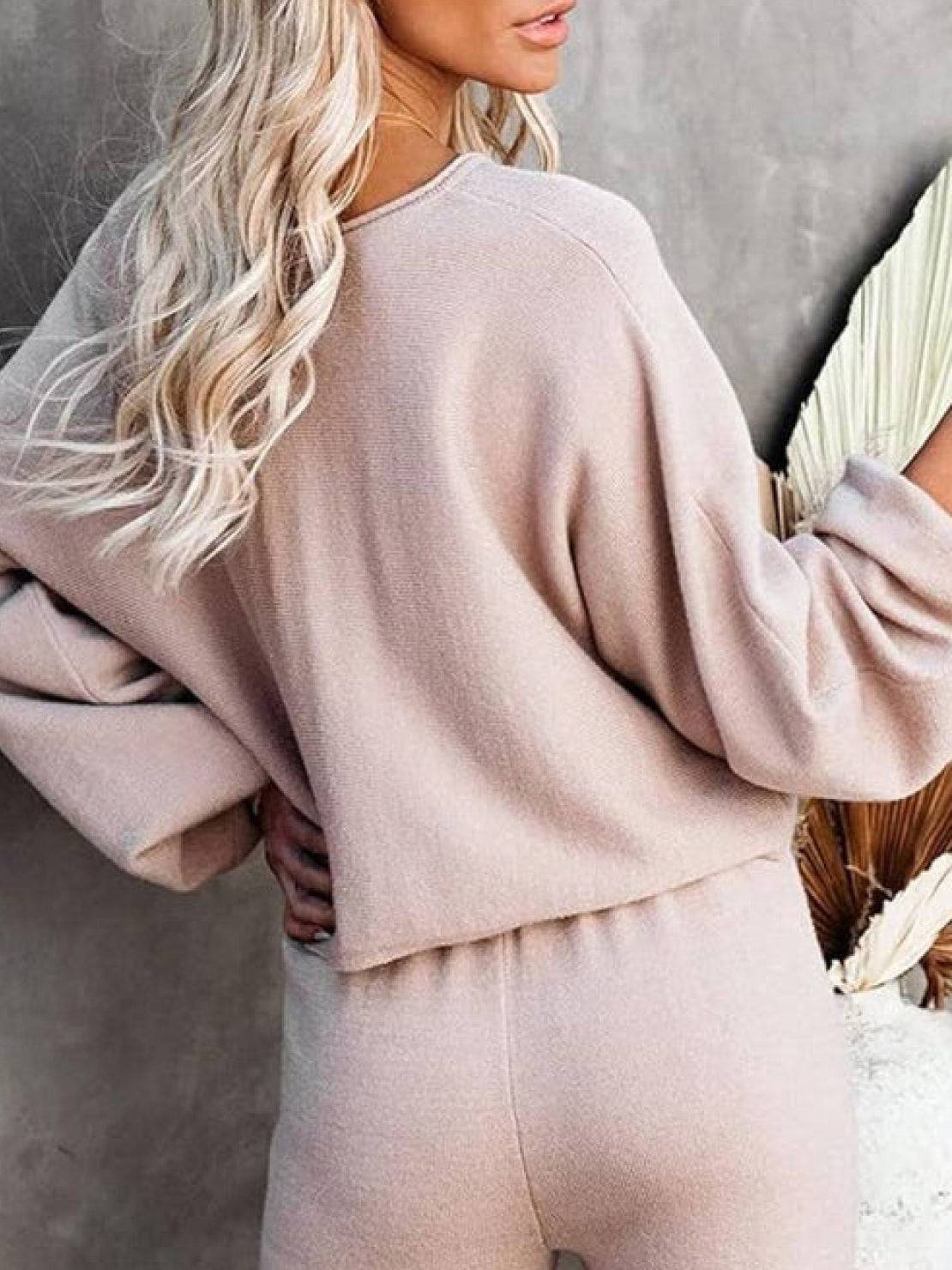 Woman wearing beige round neck loose fit cozy two-piece set with long sleeves and wide-leg pants