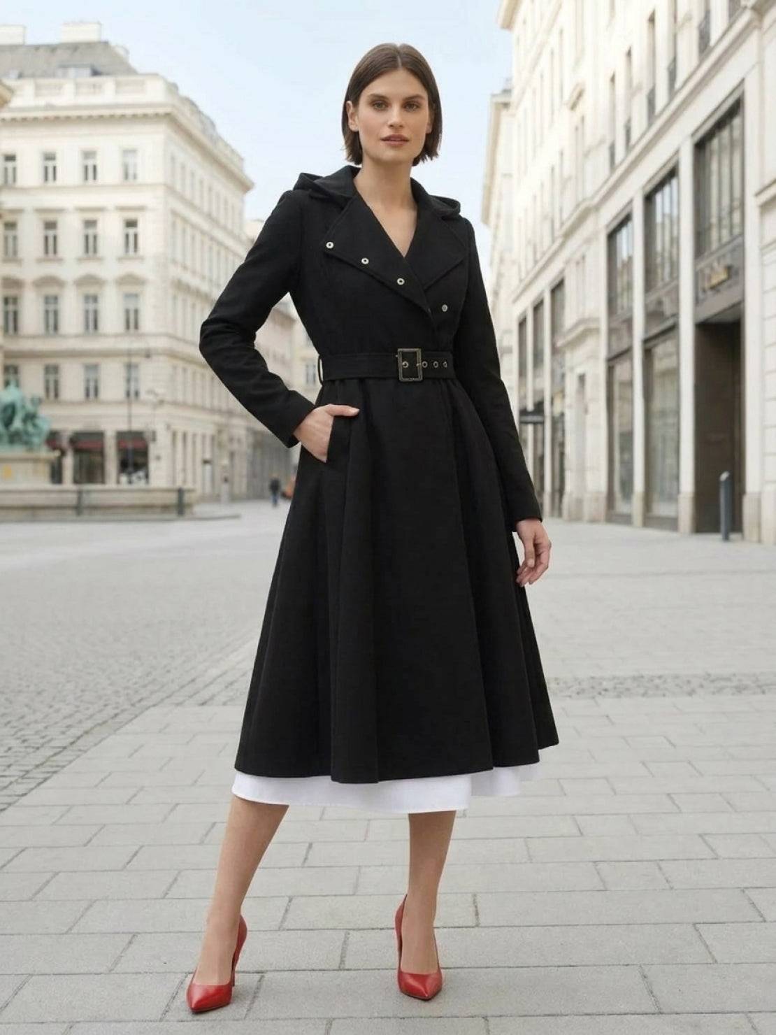 Woman wearing water-repellent A-line hooded raincoat with belt outdoors