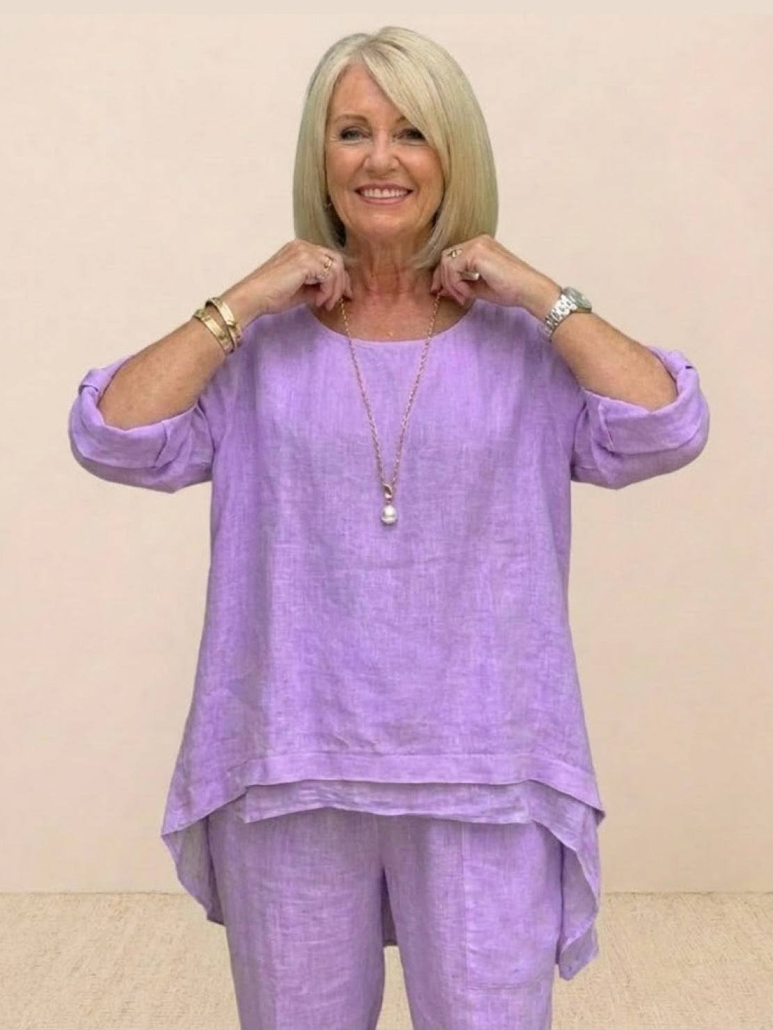 Asymmetrical two-piece trouser set in soft lavender with loose fit and rolled-up sleeves