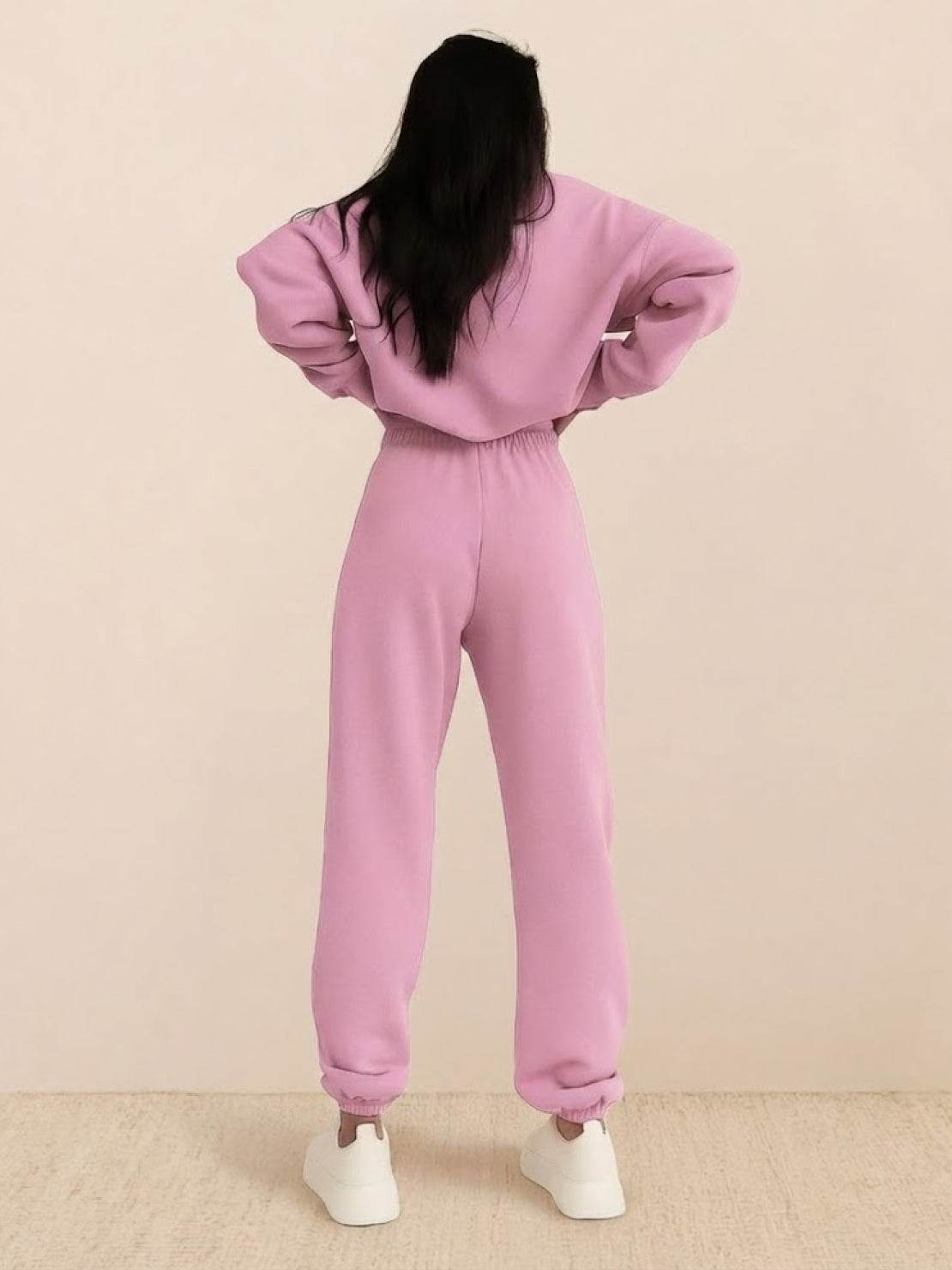 Woman wearing a cotton-blended two-piece tracksuit with high collar and zipper on city street