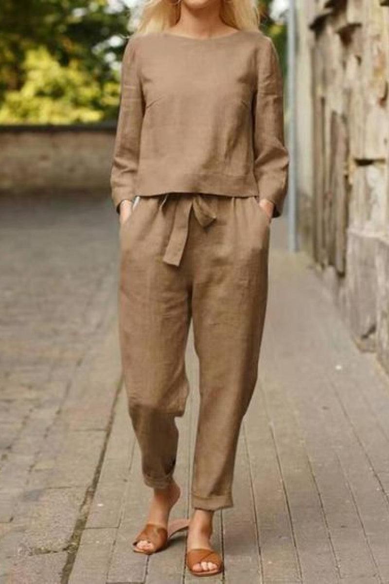 Woman wearing relaxed cotton-linen monochrome taupe top and wide-leg pants set with sandals walking outdoors