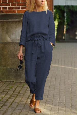 woman wearing navy blue cotton-linen monochrome capsule relaxed longline top and wide-leg pants set walking outdoors