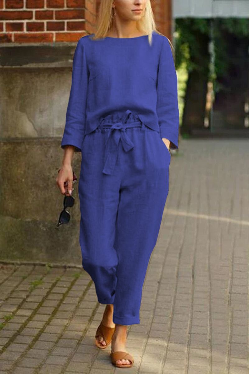 woman wearing blue cotton-linen monochrome relaxed longline top and wide-leg pants walking outdoors