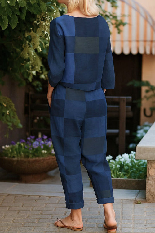 Woman wearing blue cotton-linen monochrome capsule outfit with relaxed longline top and wide-leg pants standing outdoors