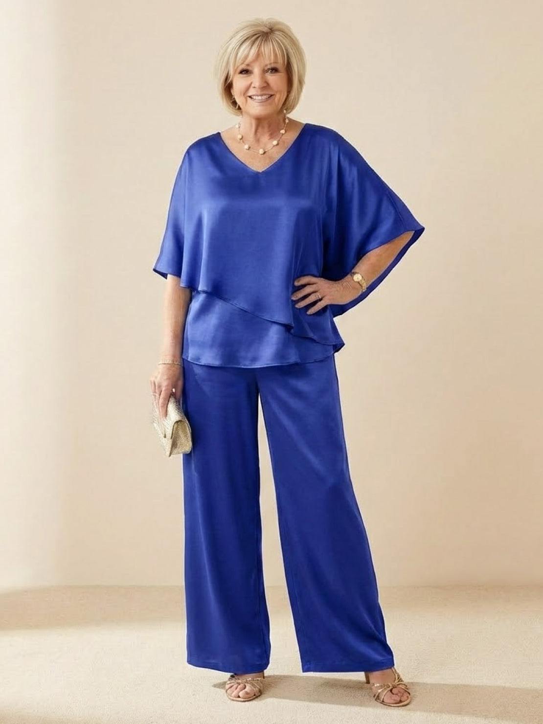 Woman wearing Elegant Layers Two-Piece Set with layered V-neck top and matching pants in neutral tones