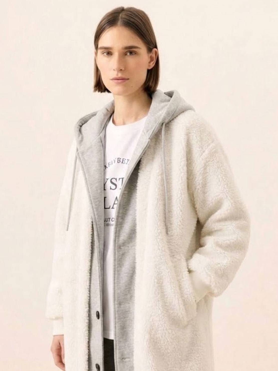 Woman wearing cozy white oversized sherpa long coat with hood and soft fabric, perfect everyday wear oversized coat for cold weather.