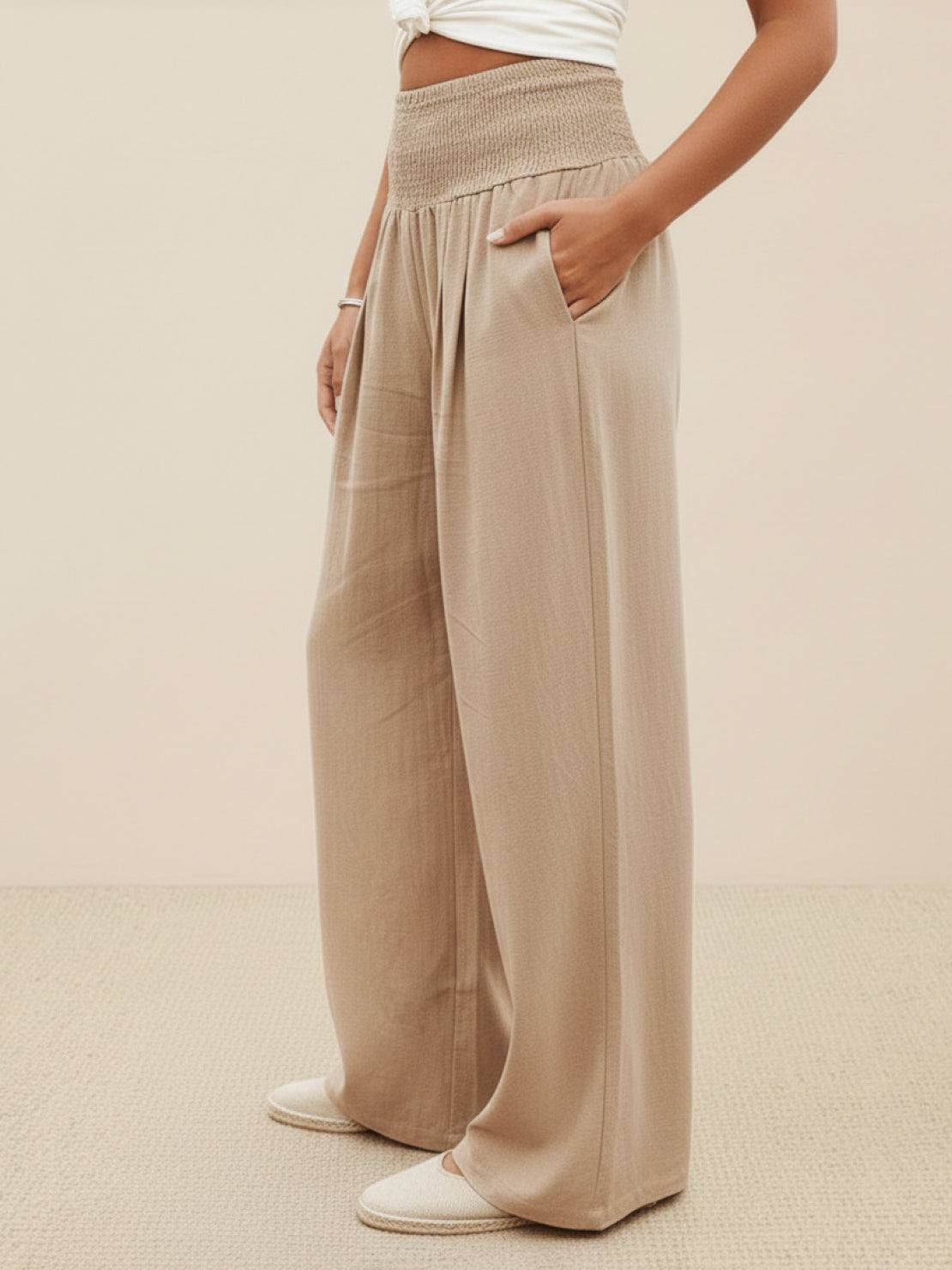 Beige high-waist palazzo pants with wide legs and pockets, made of breathable cotton linen blend