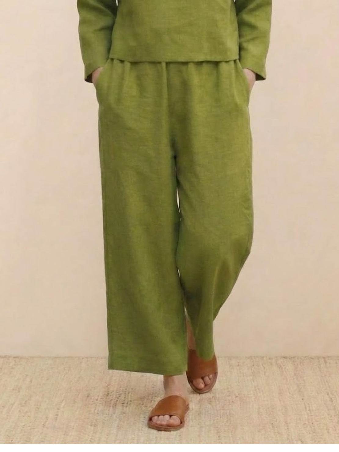 woman wearing loose solid color two-piece set with wide-leg pants and round-neck top