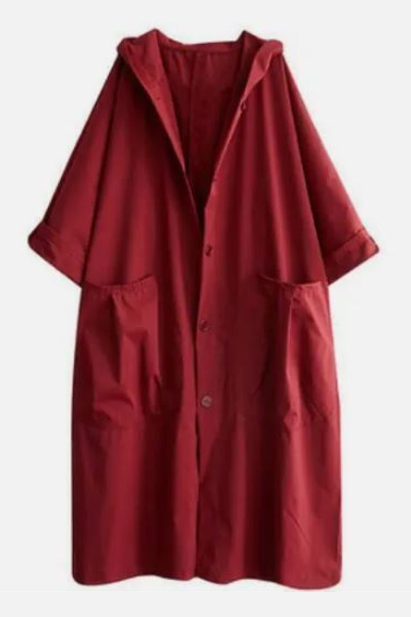 Red oversized water-resistant windbreaker jacket with hood and large front pockets, featuring a waterproof design.