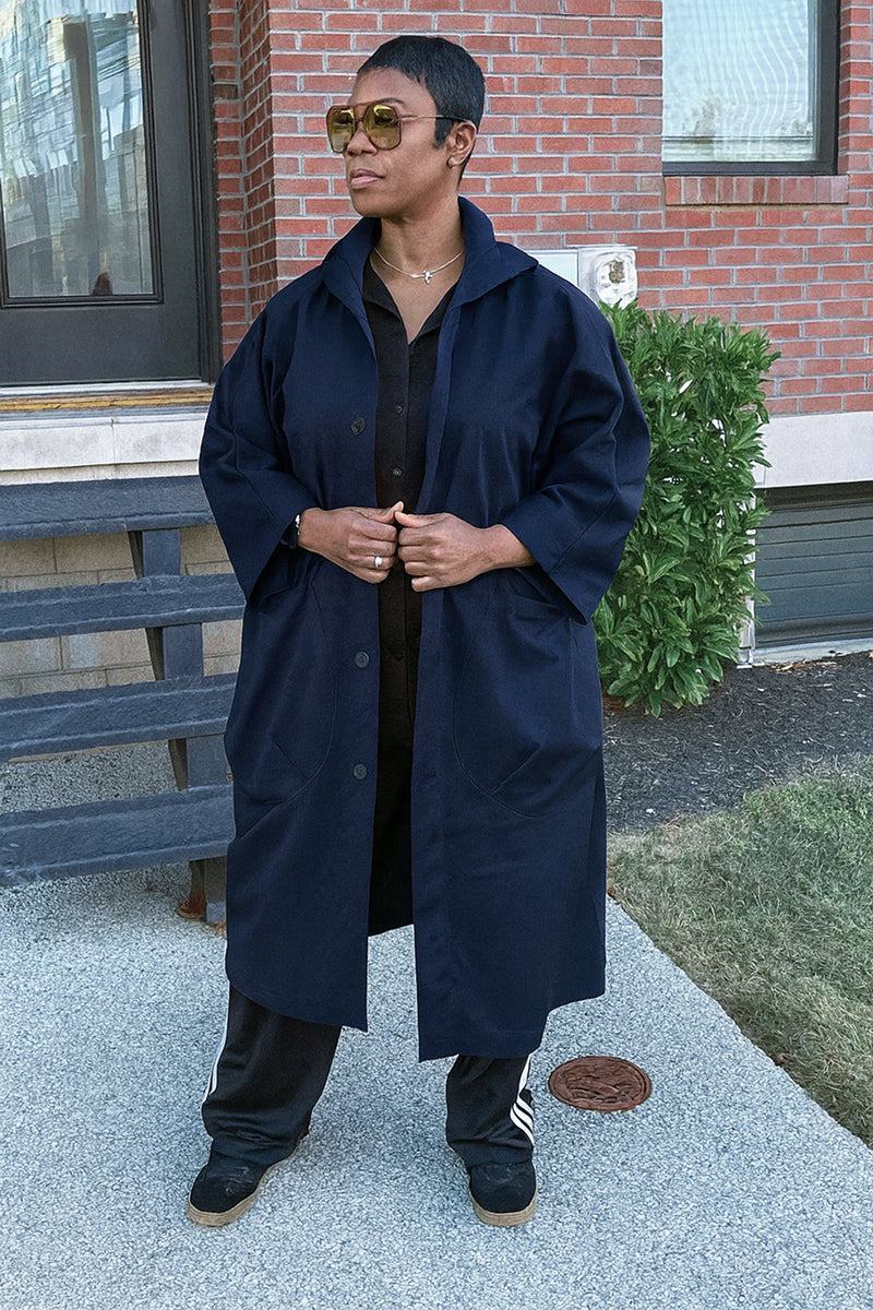 One size fits all oversized water-resistant windbreaker jacket with waterproof design and attached hood.