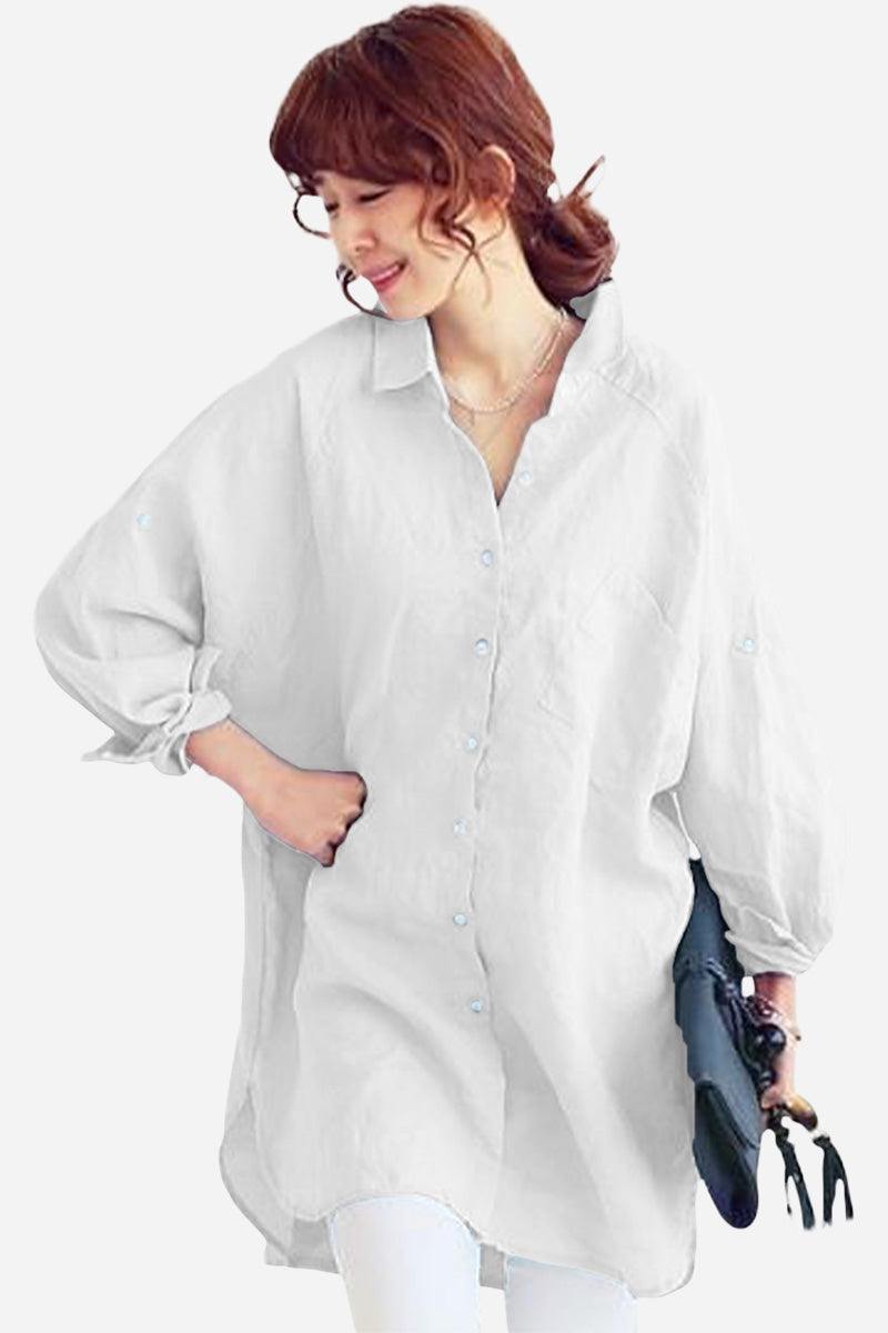 White oversized linen shirt with relaxed fit and button-down front worn by a woman holding a purse