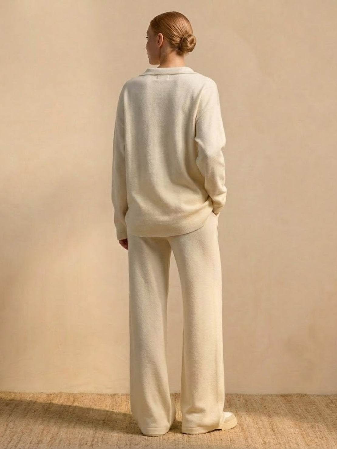 Back view of woman wearing Plush & Preppy Camel Two-Piece Set with relaxed wide-leg pants and long-sleeve pullover against beige background