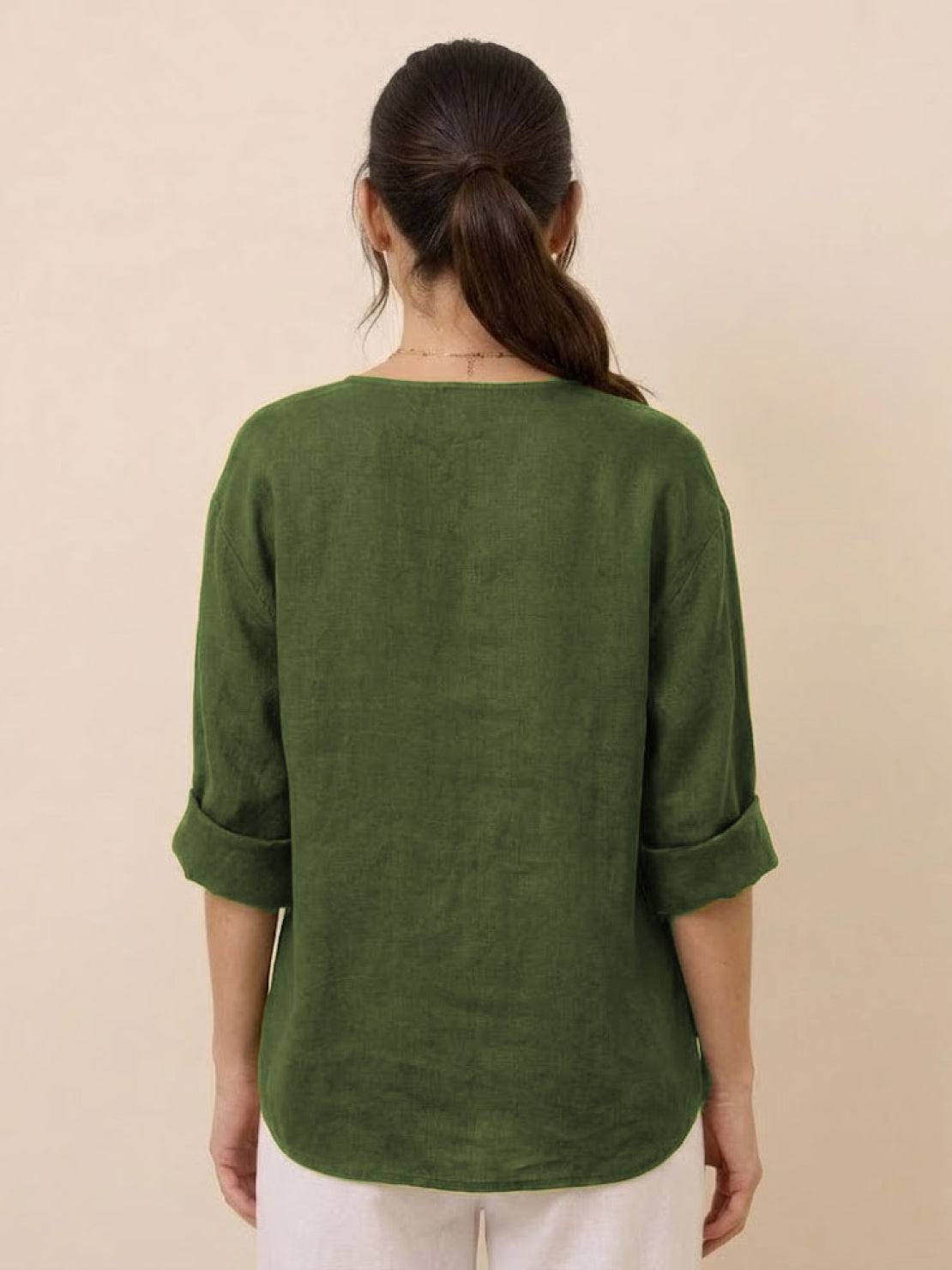 close-up of a pure linen age-defying shirt with button detail on a beige fabric background