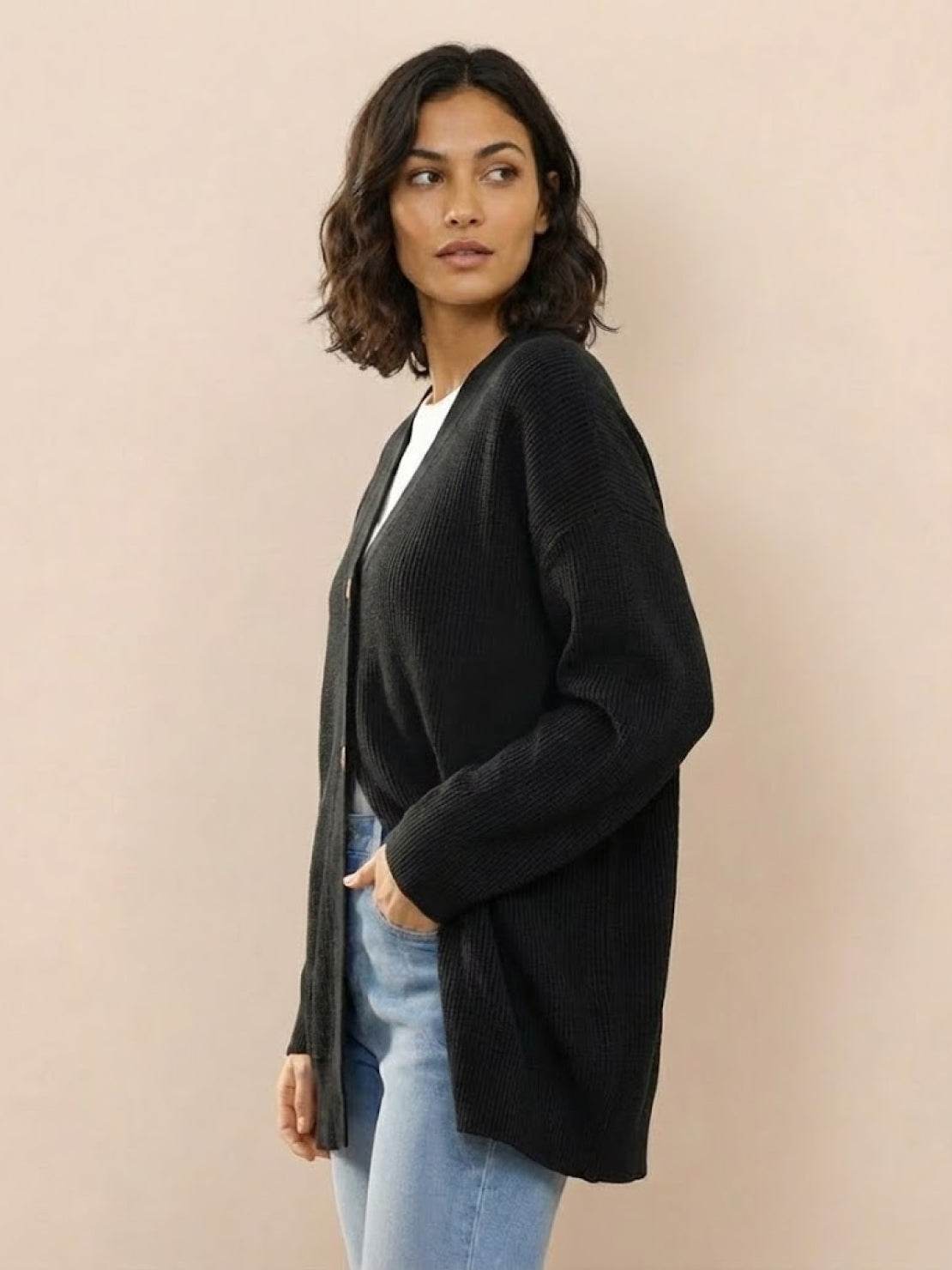 Relaxed fit oversized black knitwear cardigan button down on model with casual jeans and white top
