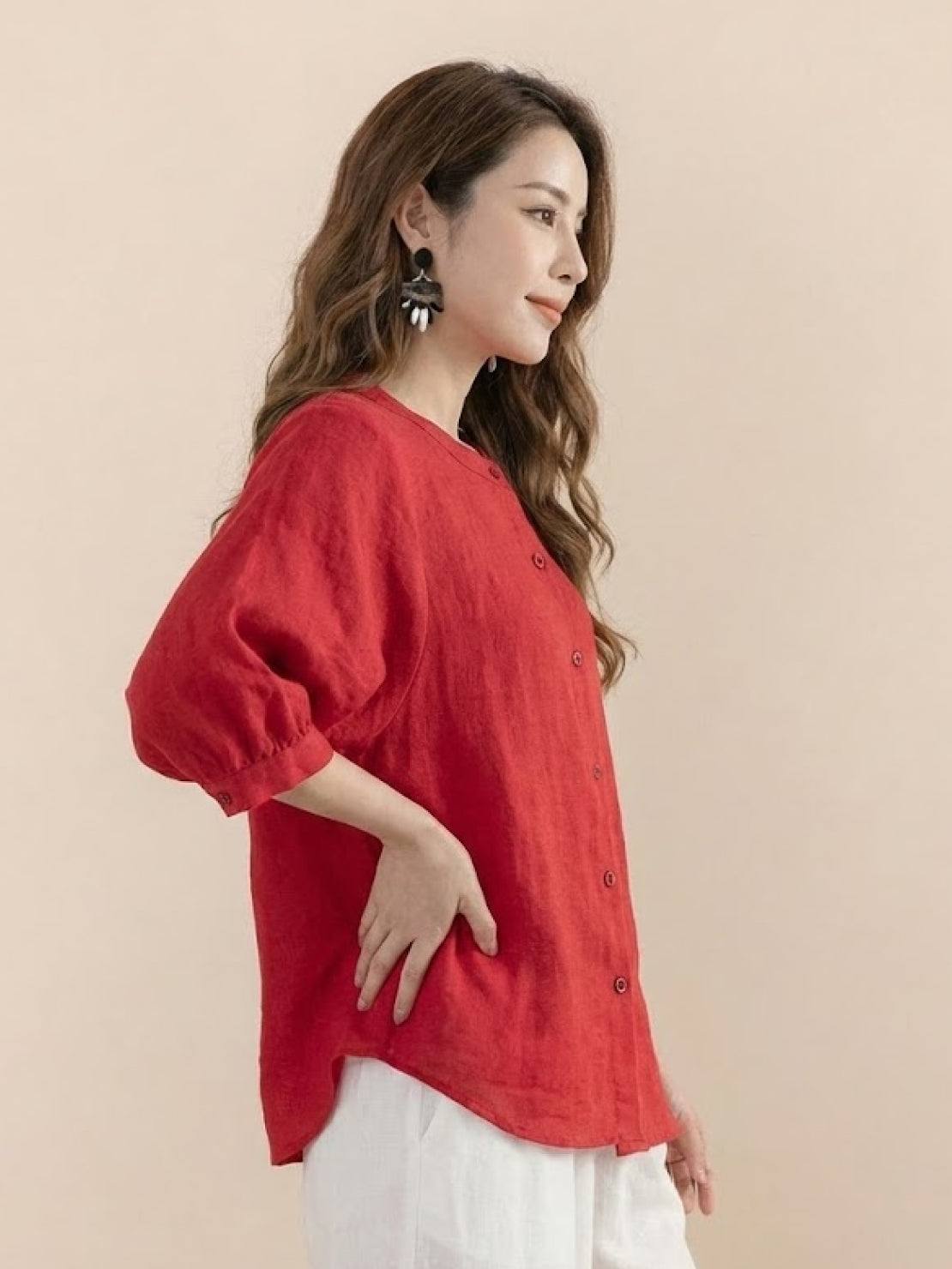Relaxed loose breathable linen blouse in vibrant red with button-down front and three-quarter sleeves.
