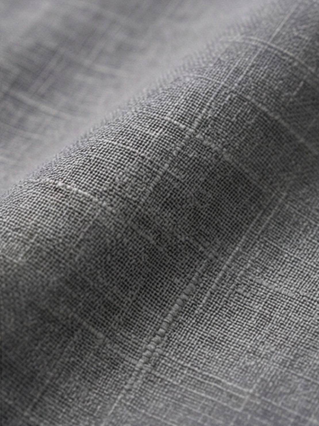 Woman wearing a relaxed shirt and trousers two-piece set in a casual, monochrome style