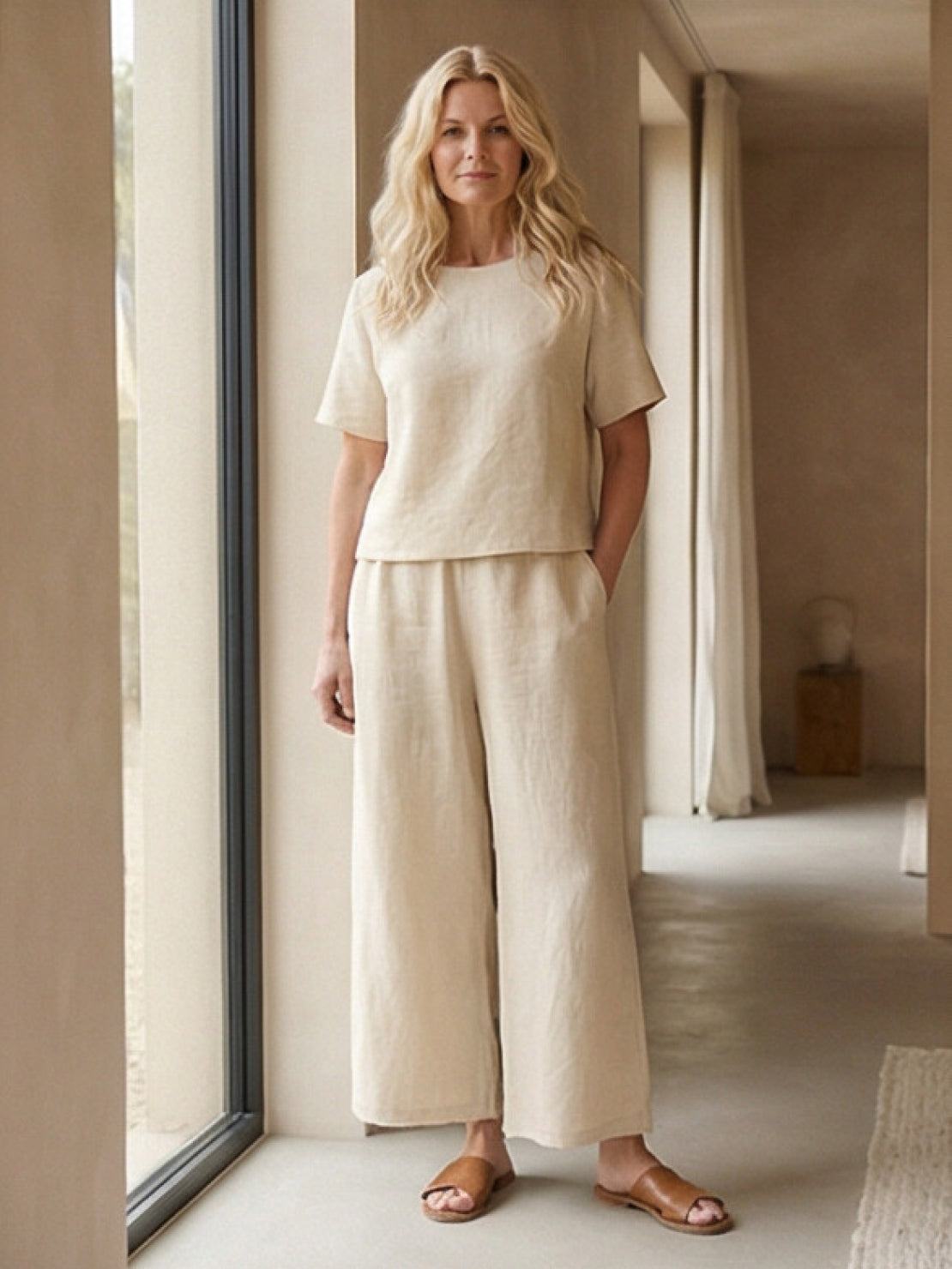 Woman wearing a relaxed loose fit co-ord set with soft-tailored top and wide-leg bottoms in a light, breathable fabric