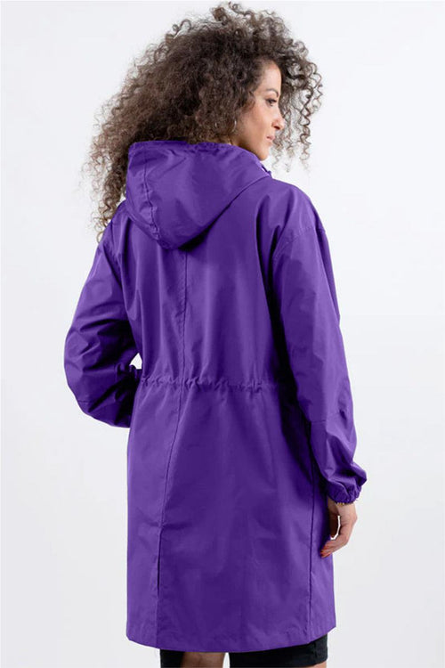 Woman wearing a purple oversized Rain Couture Windbreaker with hood, back view
