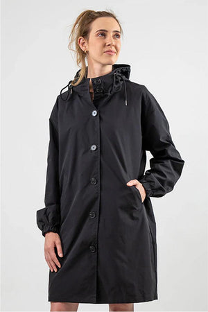 Black Rain Couture Windbreaker jacket with oversized fit, hood, and button closure worn by woman