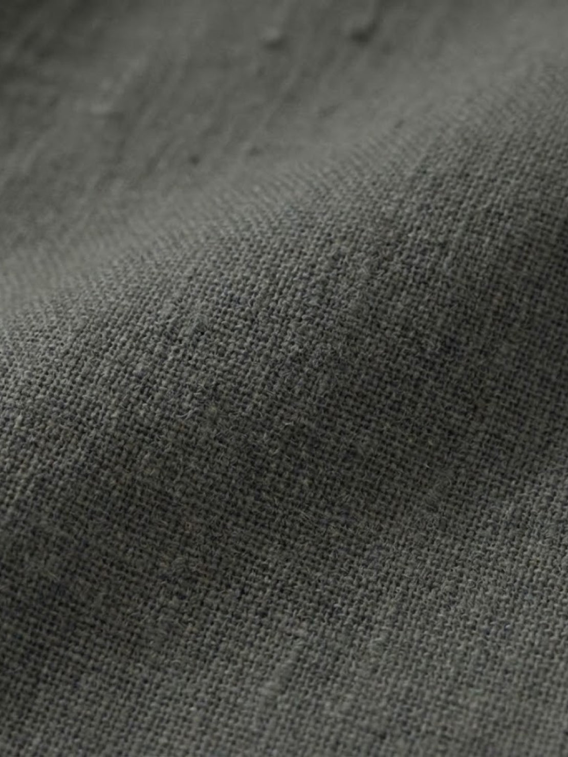 Close-up of gray cotton dress fabric texture showing lightweight breathable weave