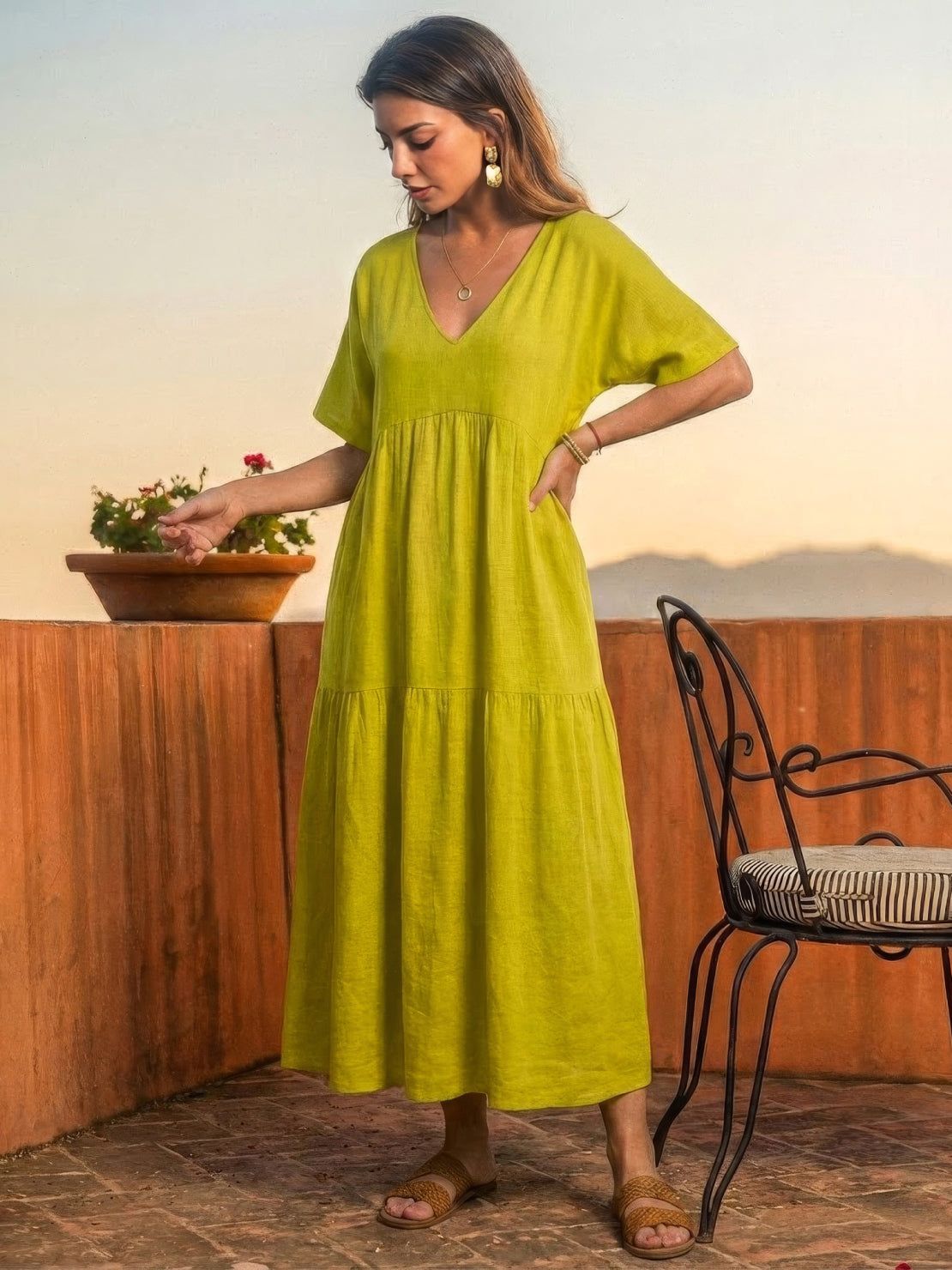 V-neck two-tiered maxi swing dress with flowing tiers and irregular hemline in solid colors