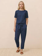 Woman wearing relaxed 100% cotton linen set with short-sleeve top and straight-leg pants in monochrome tone