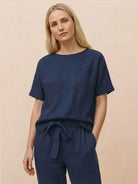 Woman wearing relaxed fit 100% cotton linen set with a monochrome short-sleeve top and straight-leg pants