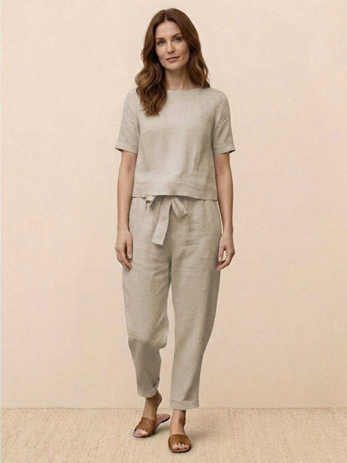 Woman wearing 100% cotton linen set with relaxed short-sleeve top and straight-leg pants in monochrome tones