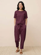 woman wearing relaxed fit cotton linen set with short-sleeve top and straight-leg pants in monochrome tones