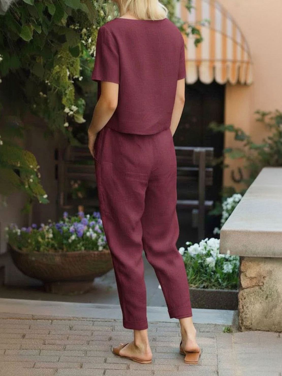 Woman wearing relaxed cotton linen set with short-sleeve top and straight-leg pants in monochrome tones