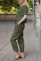 women's olive green cotton linen set with relaxed short sleeve top and straight-leg pants outdoors