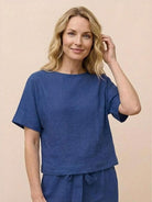 Woman wearing relaxed cotton linen set with short sleeve top and straight-leg pants in monochrome tones