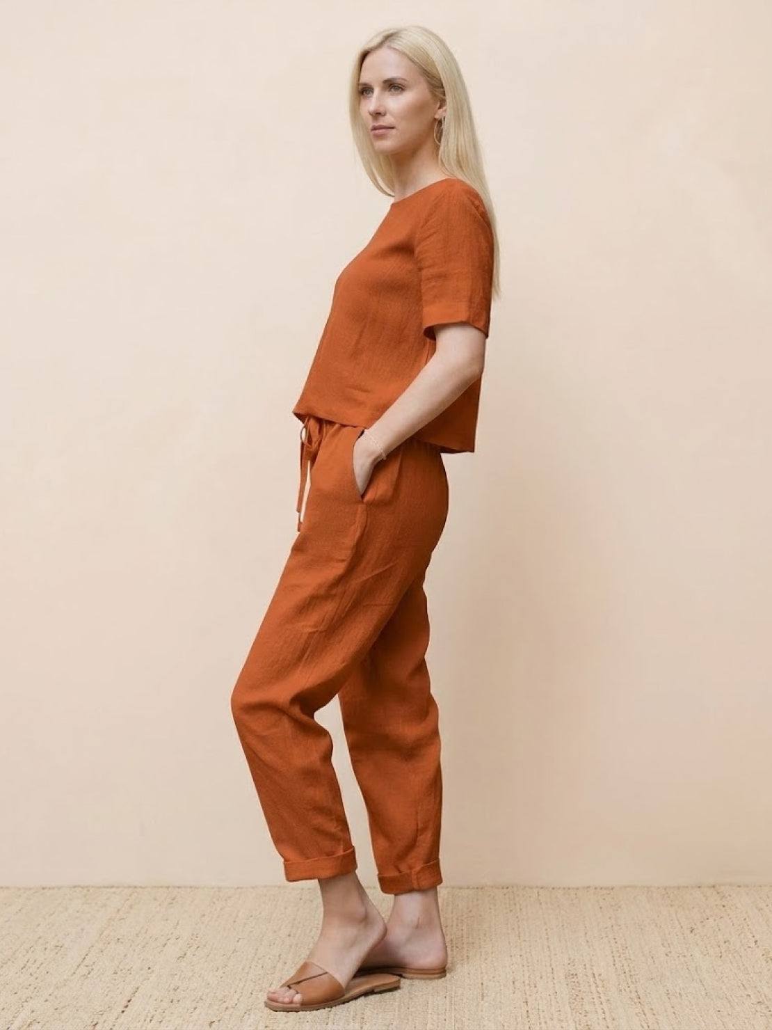 Woman wearing relaxed fit cotton linen set with short sleeve top and straight-leg pants in monochrome tones