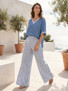 Woman wearing striped wide-leg co-ord set with oversized top and palazzo pants.